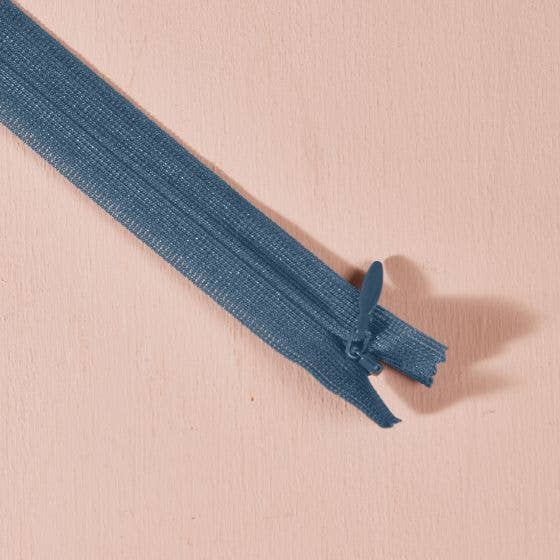 Atelier Brunette invisible zipper in slate blue, 60 cm (24 inch), a dressmaking notion for dresses and skirts shown on a blush background