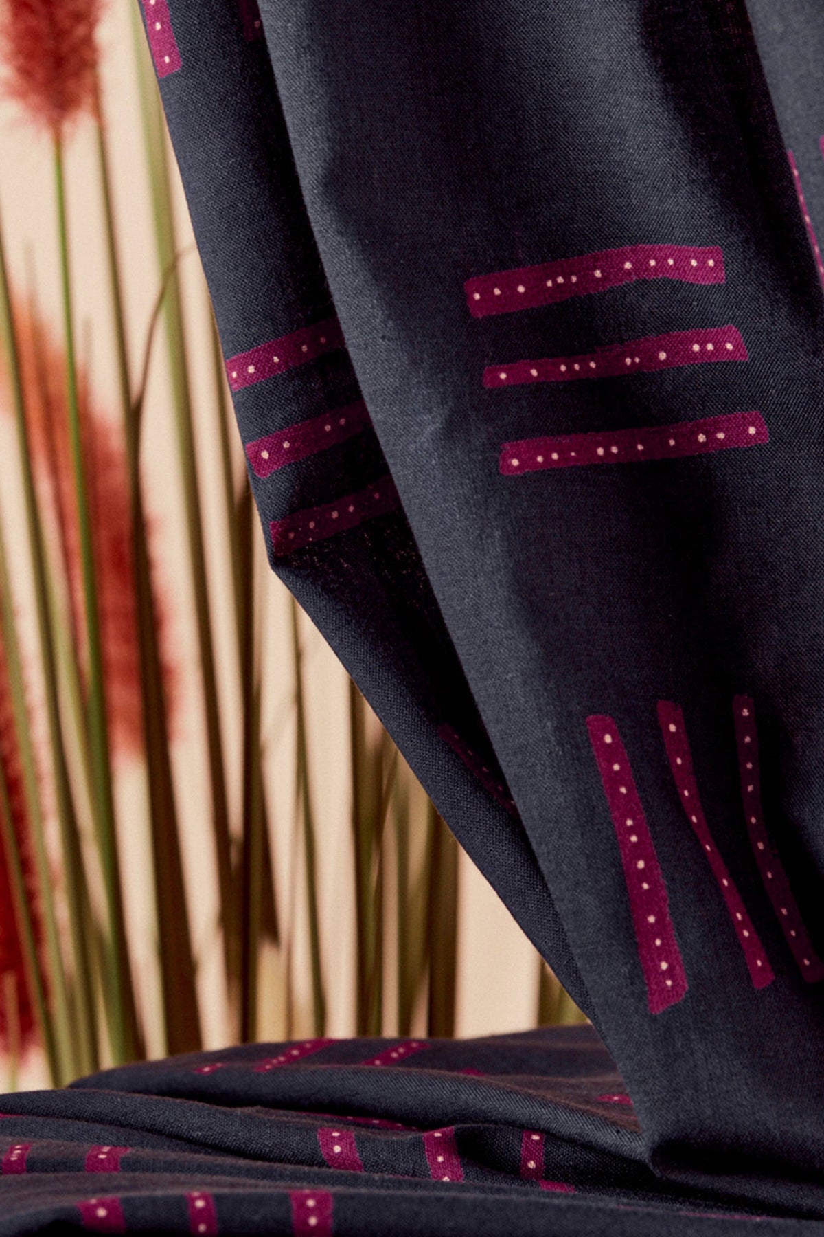 Atelier Brunette Raspberry Geo cotton gauze draped beside a window
