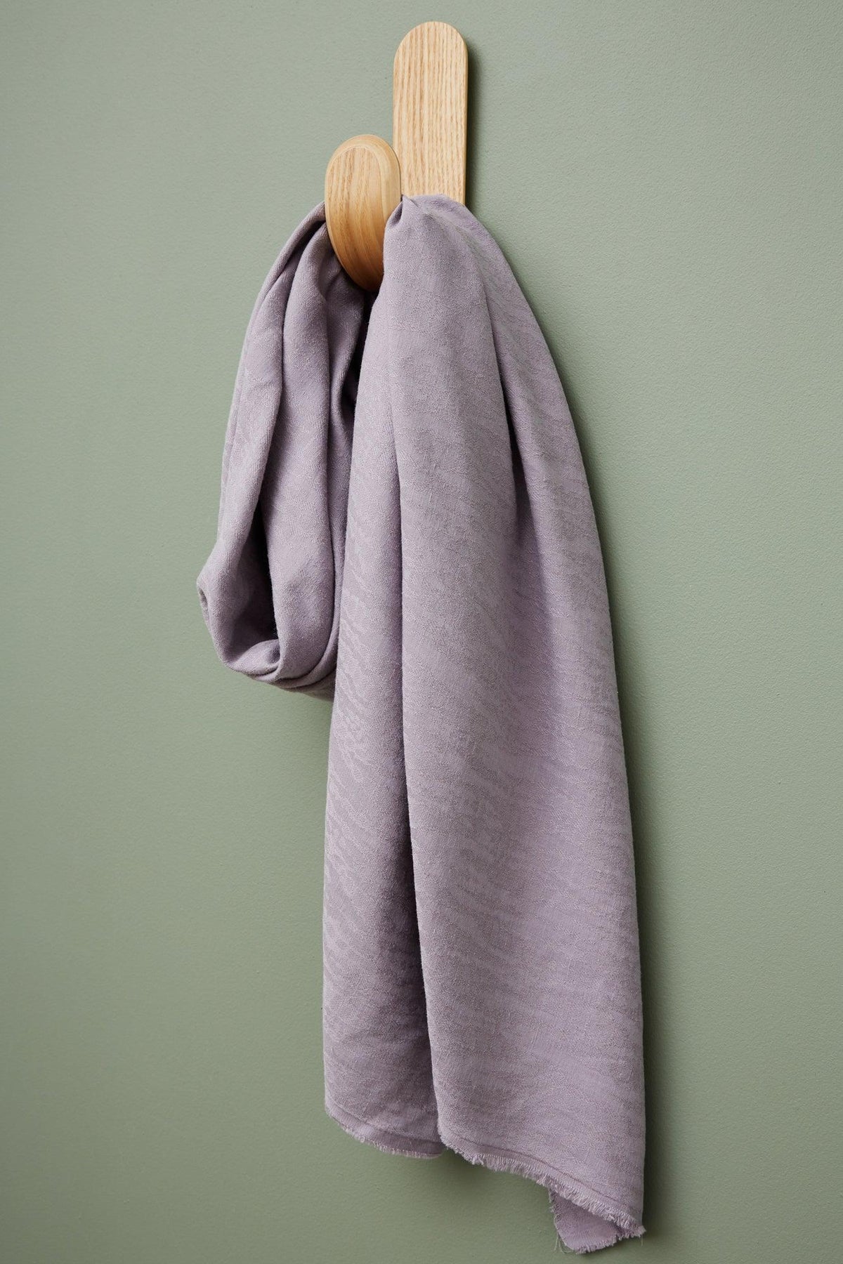 meetMILK Hoya jacquard linen blend in Purple Haze, lilac textured fabric by the half yard hanging on a hook
