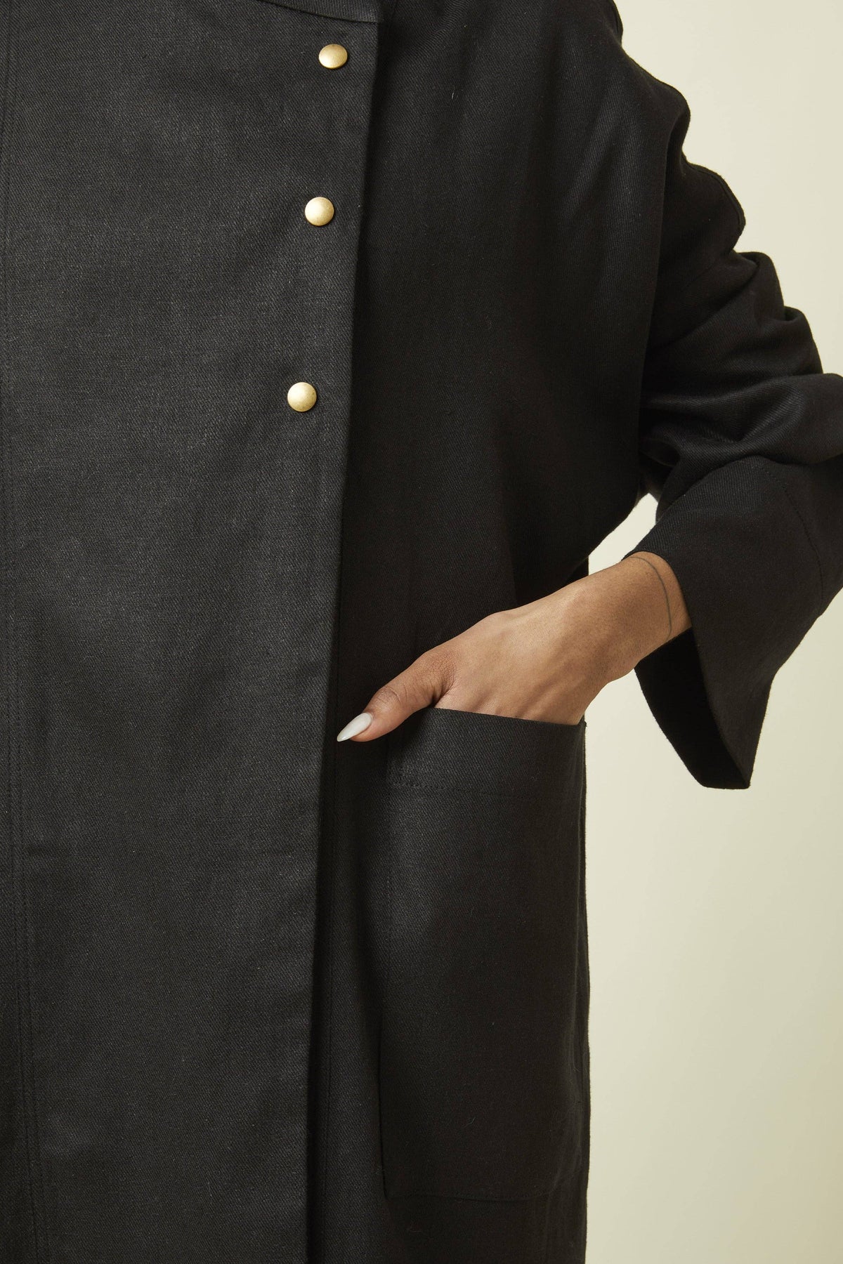 Close-up of black jacket pocket and buttons from the Atelier Brunette Troubling Jacket printed sewing pattern