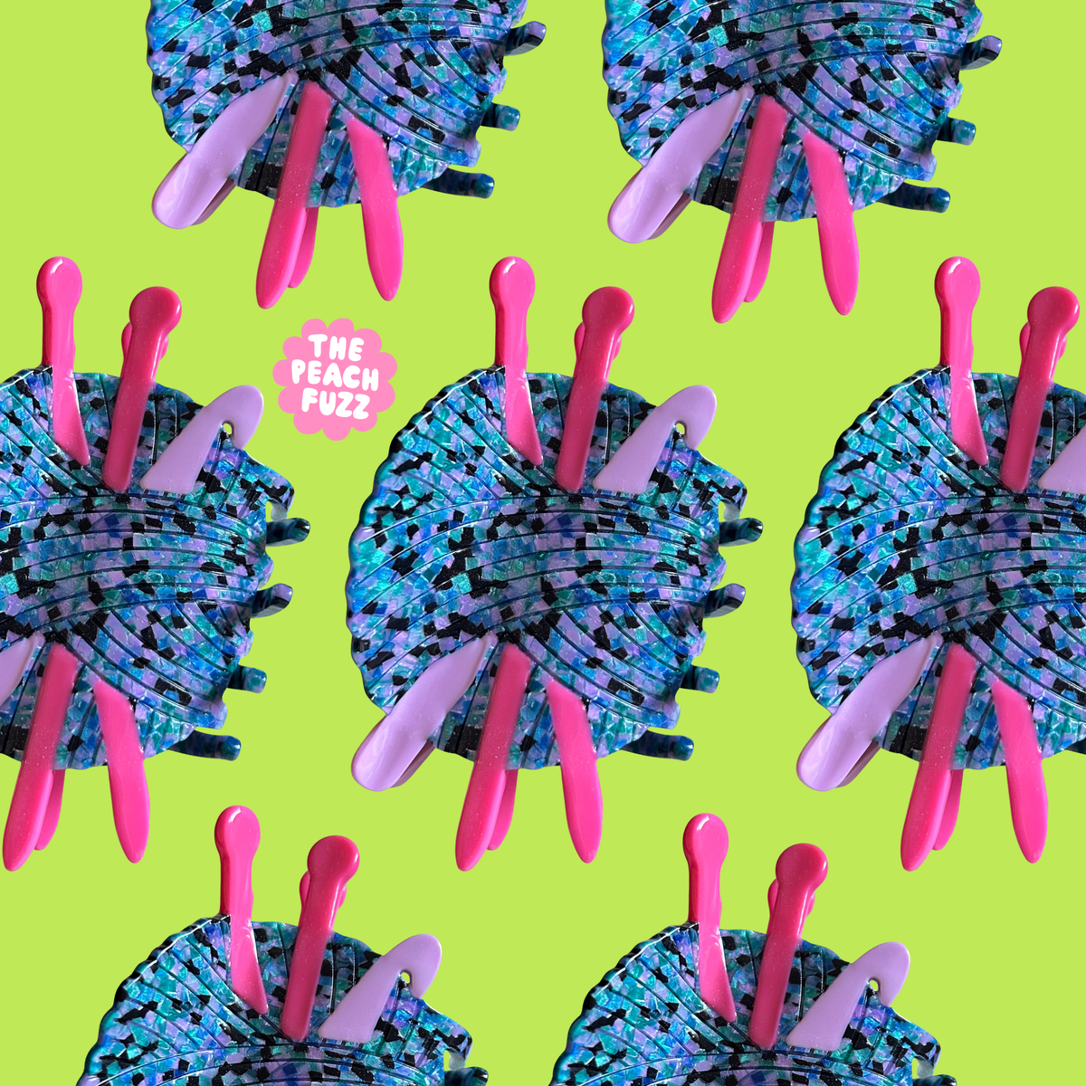 The Peach Fuzz knitting and crochet hair claws on a navy flower background