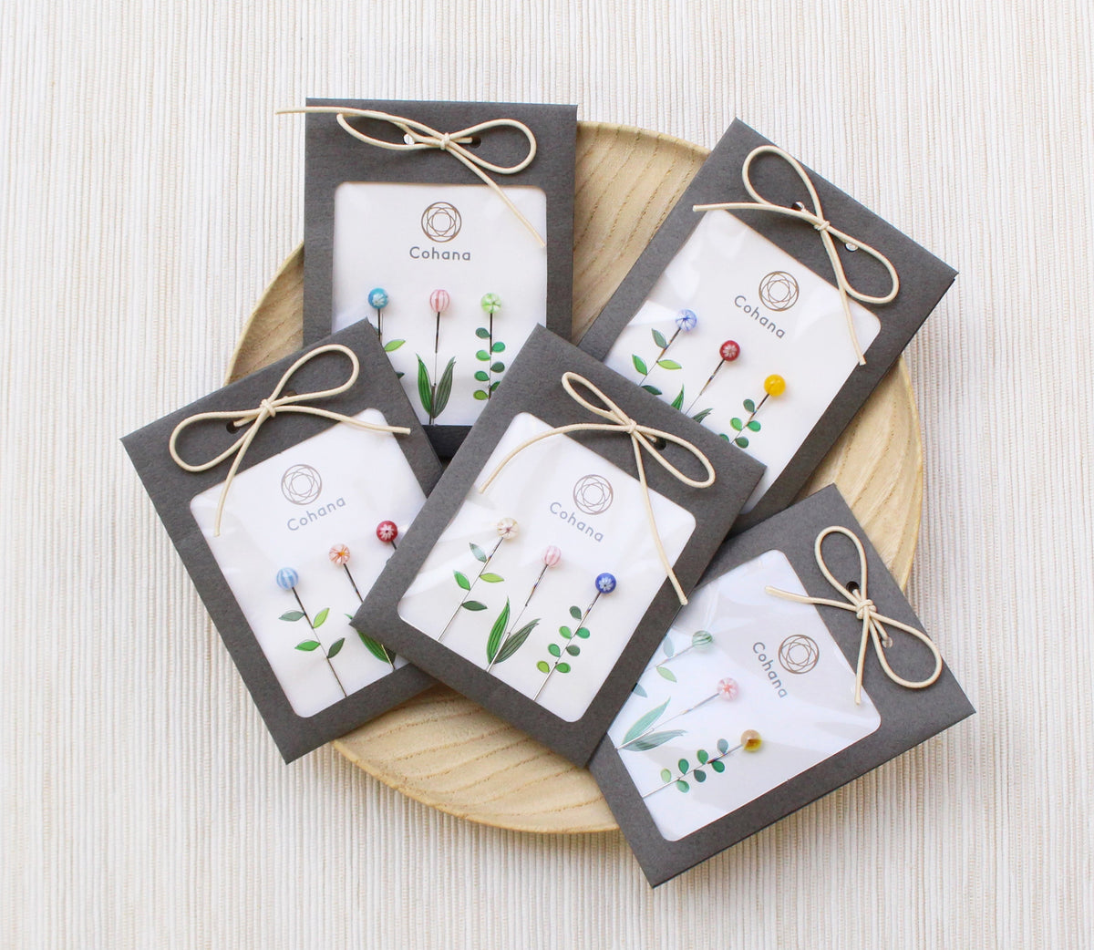 Cohana Tombo-dama glass sewing pins, several packages laid out