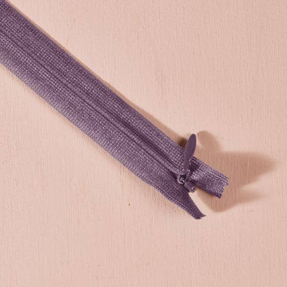 Atelier Brunette invisible zipper in divine parma purple, 40 cm (16 inch), a dressmaking notion for dresses and skirts shown on a blush background