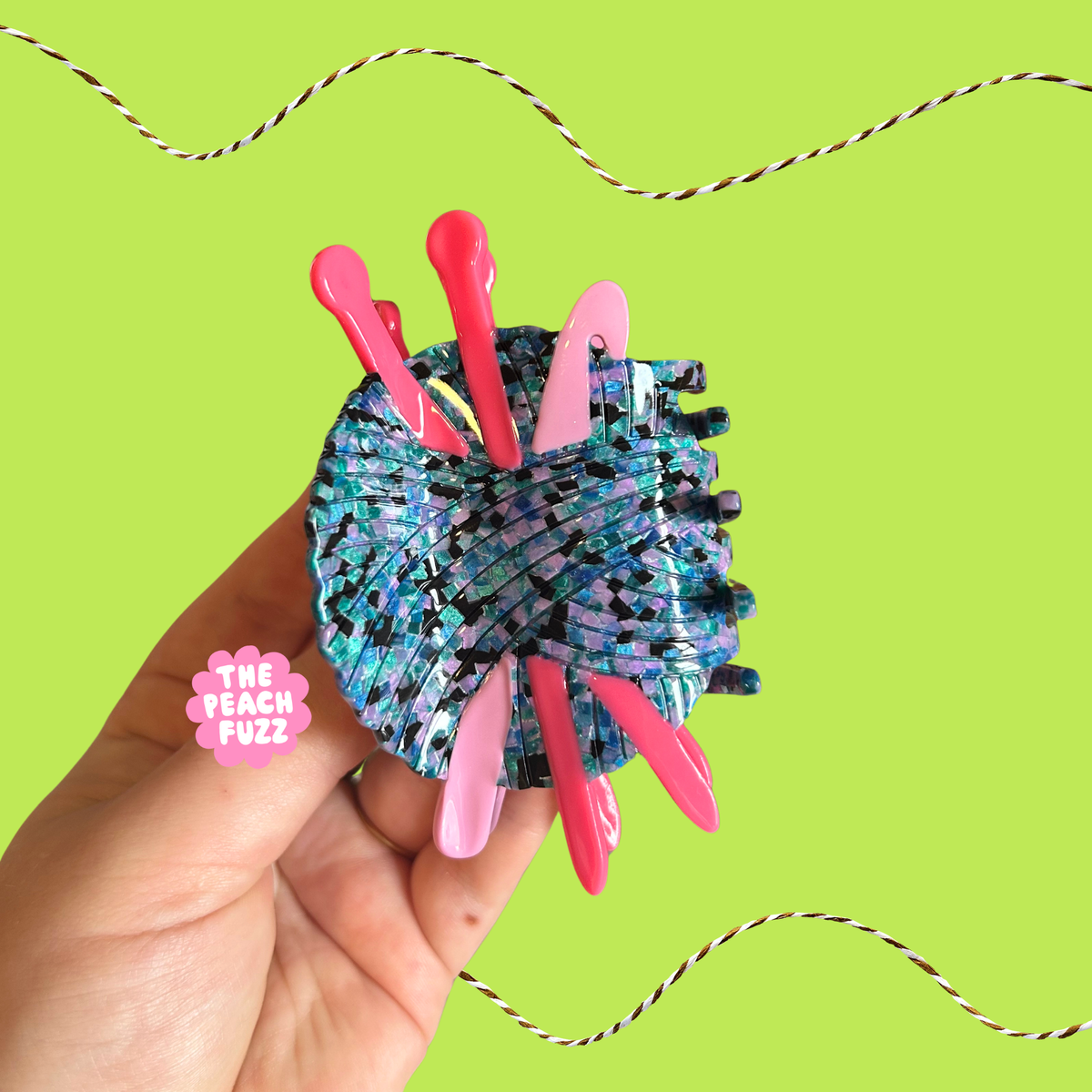 The Peach Fuzz combined knitting and crochet needle hair claw on green