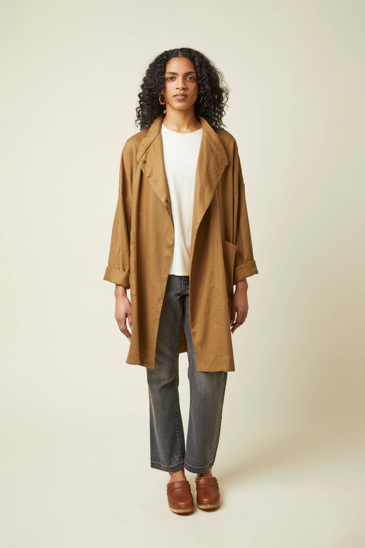 Model in a camel coat sewn from the Atelier Brunette Troubling Jacket printed sewing pattern