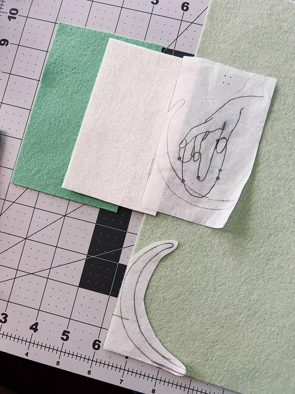 Sophie Hines The High Priestess tarot patch paper embroidery pattern sheet stuck on green fabric next to a ruler