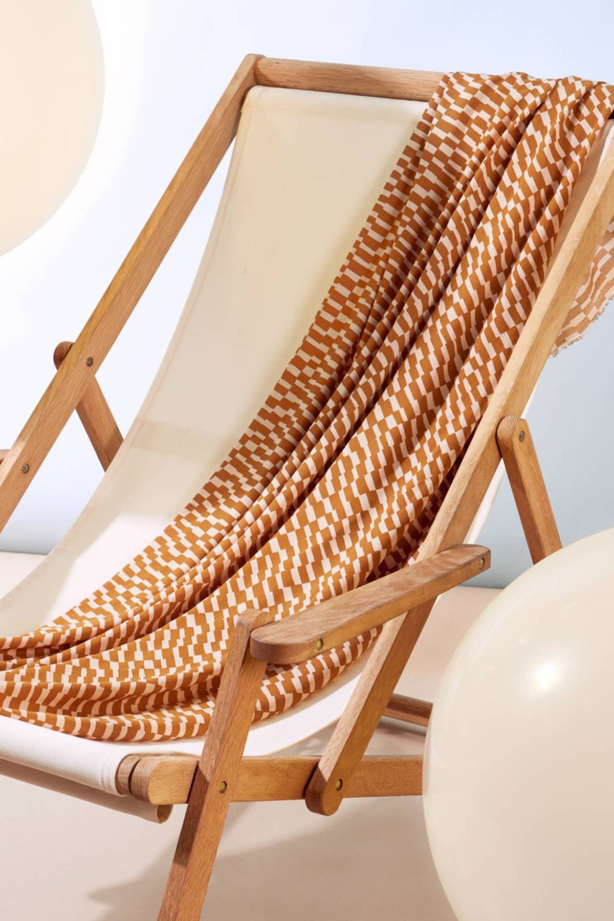 Atelier Brunette Domino Ochre viscose draped over a deck chair