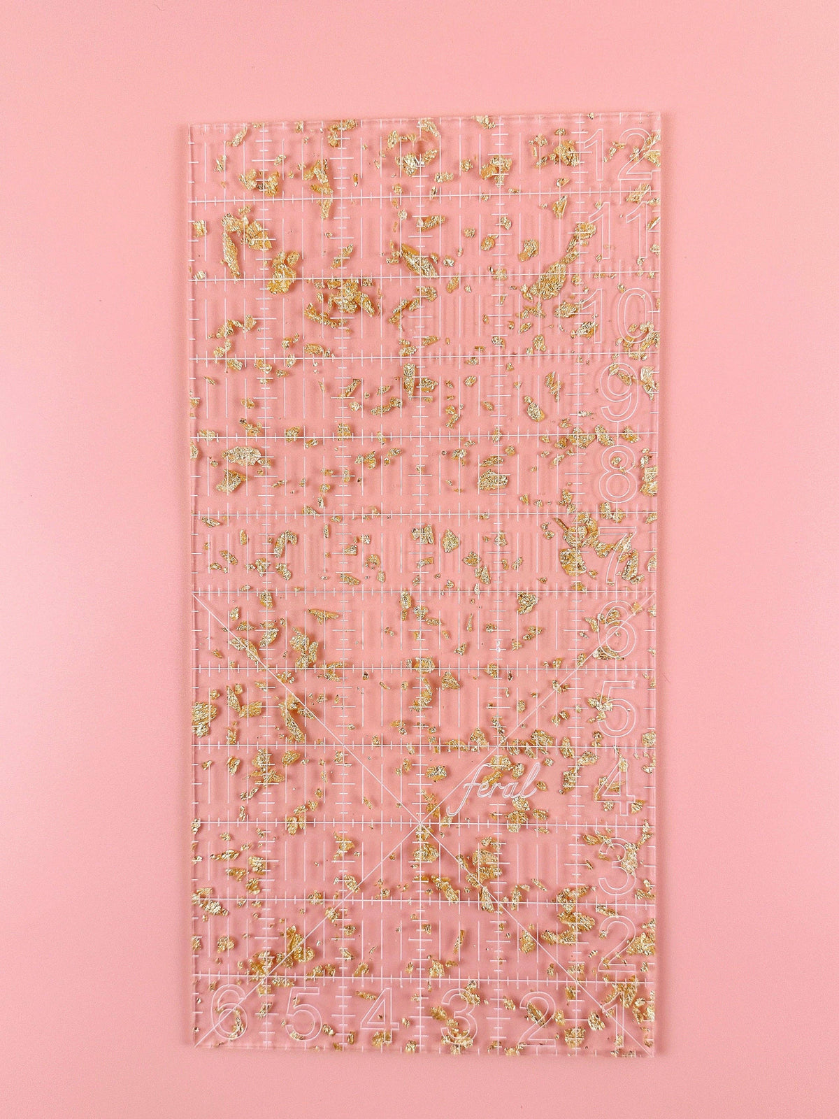 Feral Notions 6 x 12 inch quilting ruler in gold glitter acrylic, full view of the clear quilting ruler