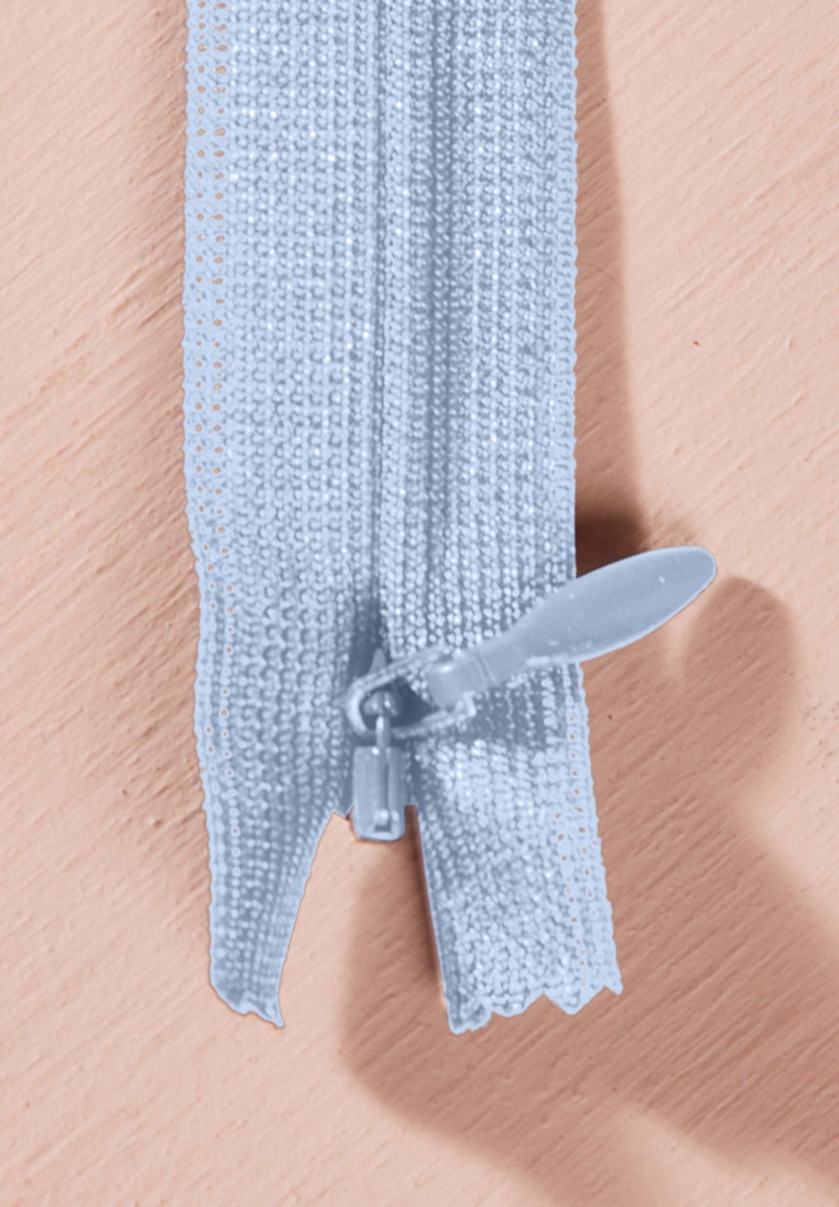 Atelier Brunette invisible zipper in pale sky blue, 40 cm (16 inch), a dressmaking notion for dresses and skirts shown on a blush background
