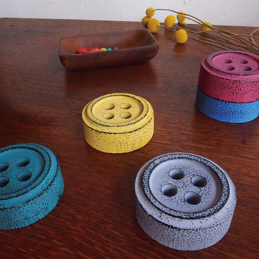 Cohana Nambu iron paperweight and pattern weight, on a wooden table with fabric