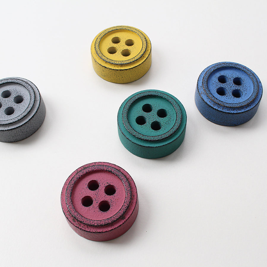 Cohana Nambu iron paperweight and pattern weight, in four colors scattered