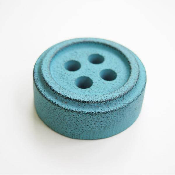 Cohana Nambu iron paperweight and pattern weight, shaped like a teal button
