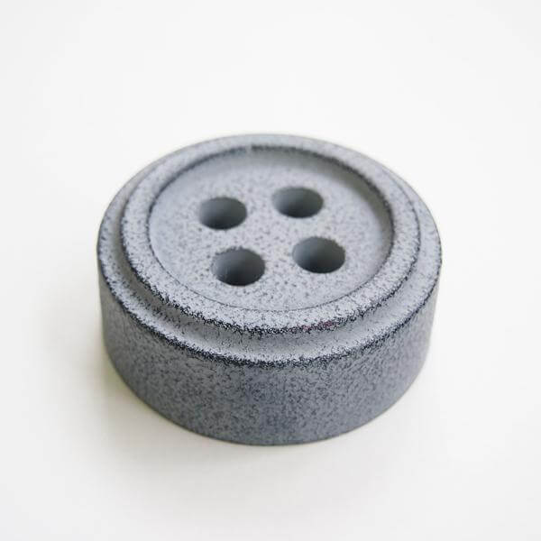 Cohana Nambu iron paperweight and pattern weight, in grey on white