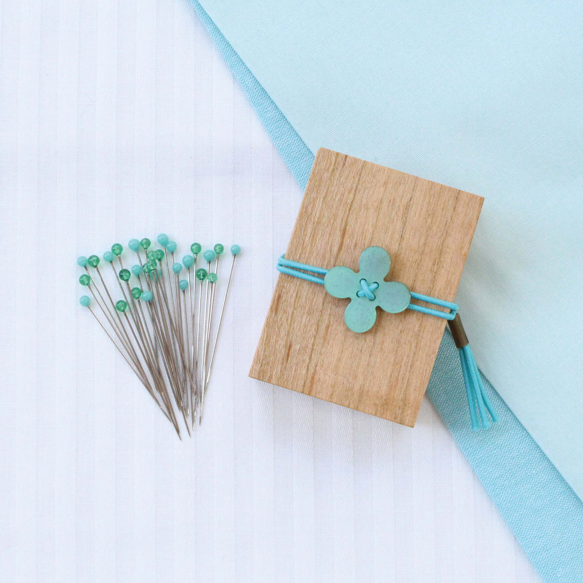 Cohana glass sewing pins in a cherry-wood box, with teal flower pins