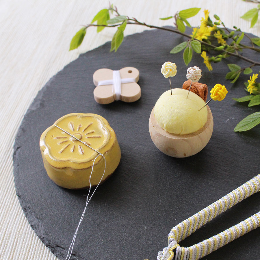 Cohana Awaji Kawara magnetic needle rest with needle polisher, with yellow and cream on wood
