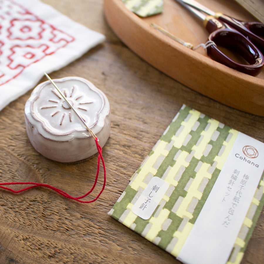 Cohana assorted needles in a Haibara chiyogami paper pack, pack on a wooden table