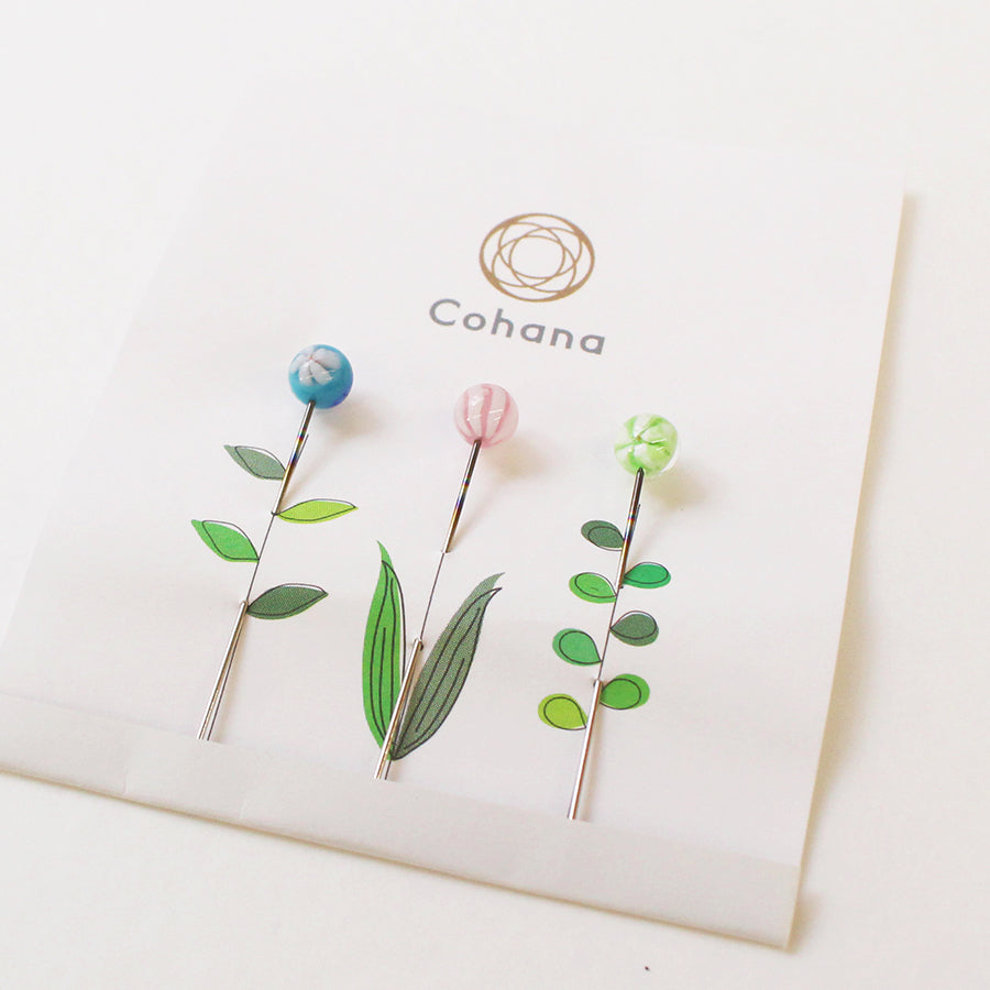 Cohana Tombo-dama glass sewing pins, arranged in a flower pattern on card