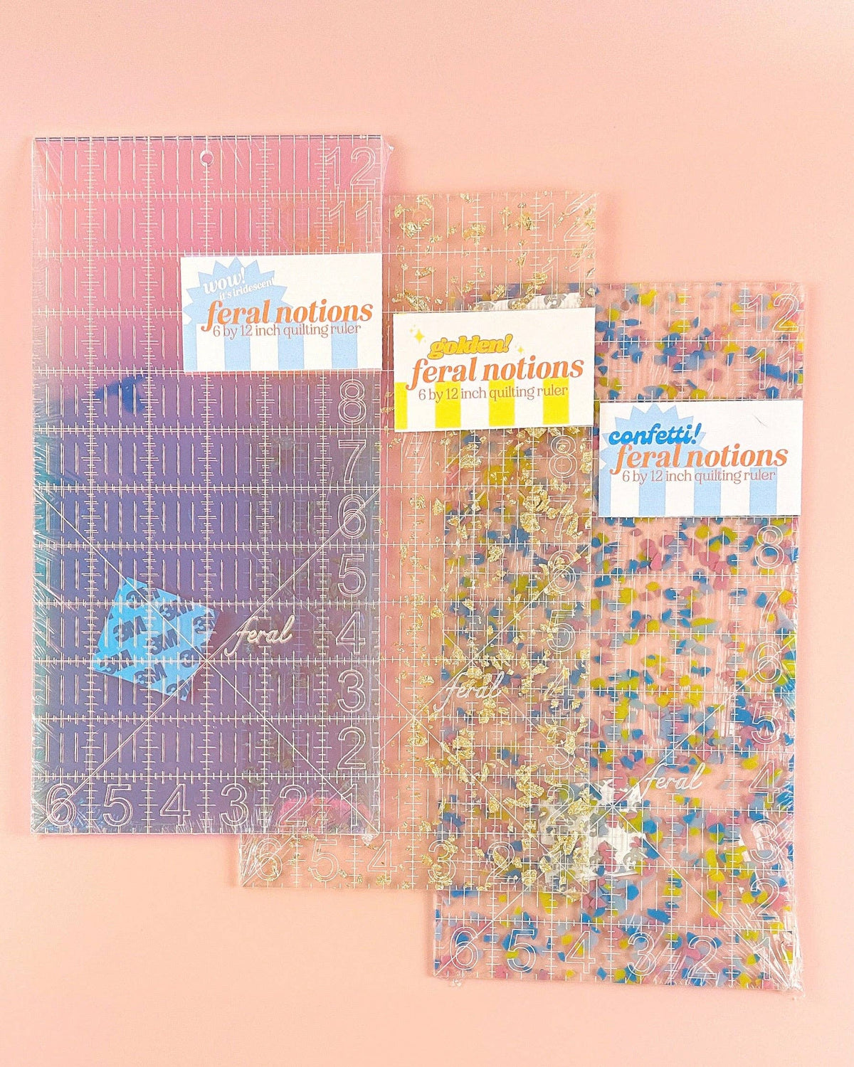 Feral Notions 6 x 12 inch quilting ruler three colorways in packaging with labels, confetti, gold glitter and iridescent