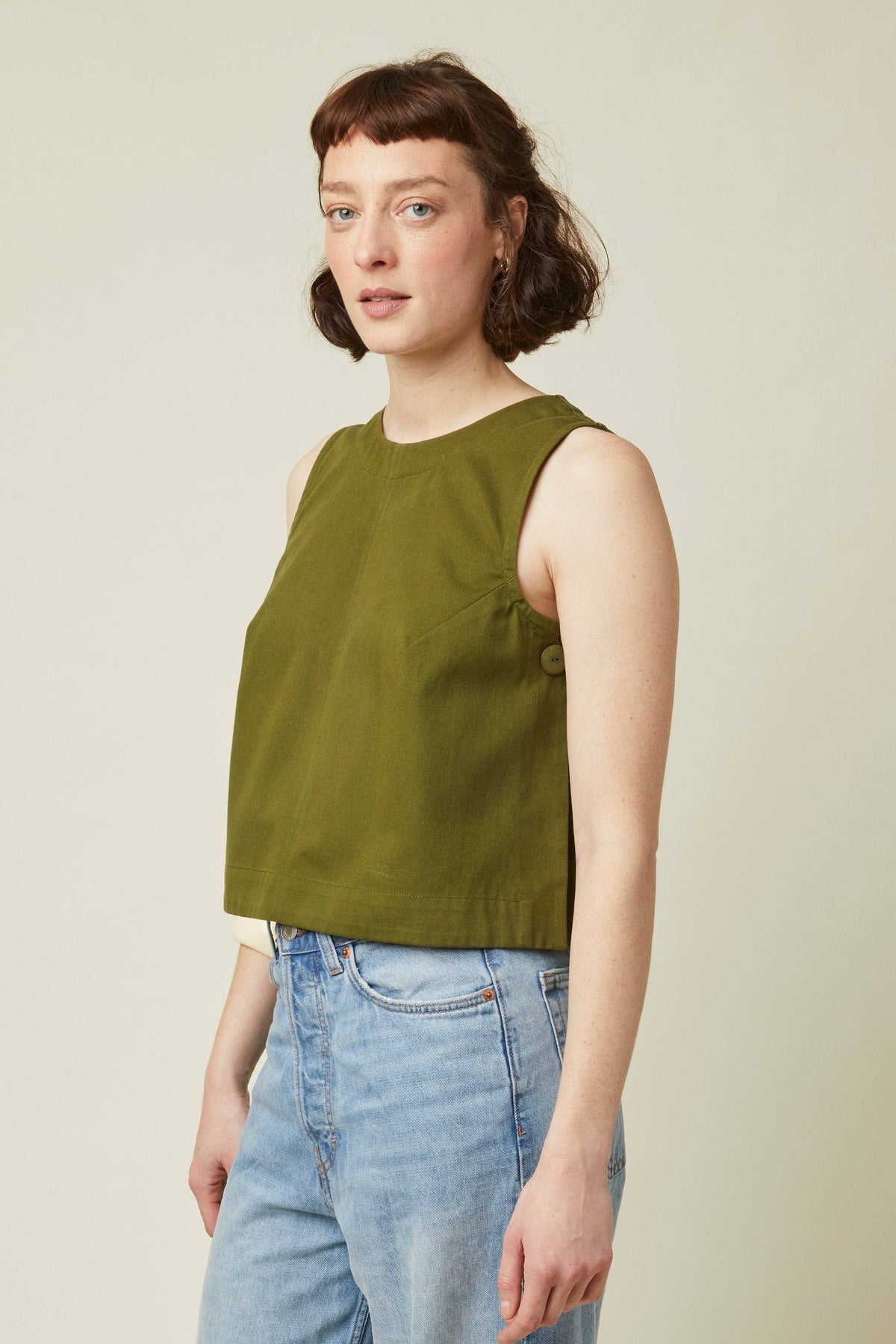 Side view of an olive top made with the Atelier Brunette The Top printed sewing pattern
