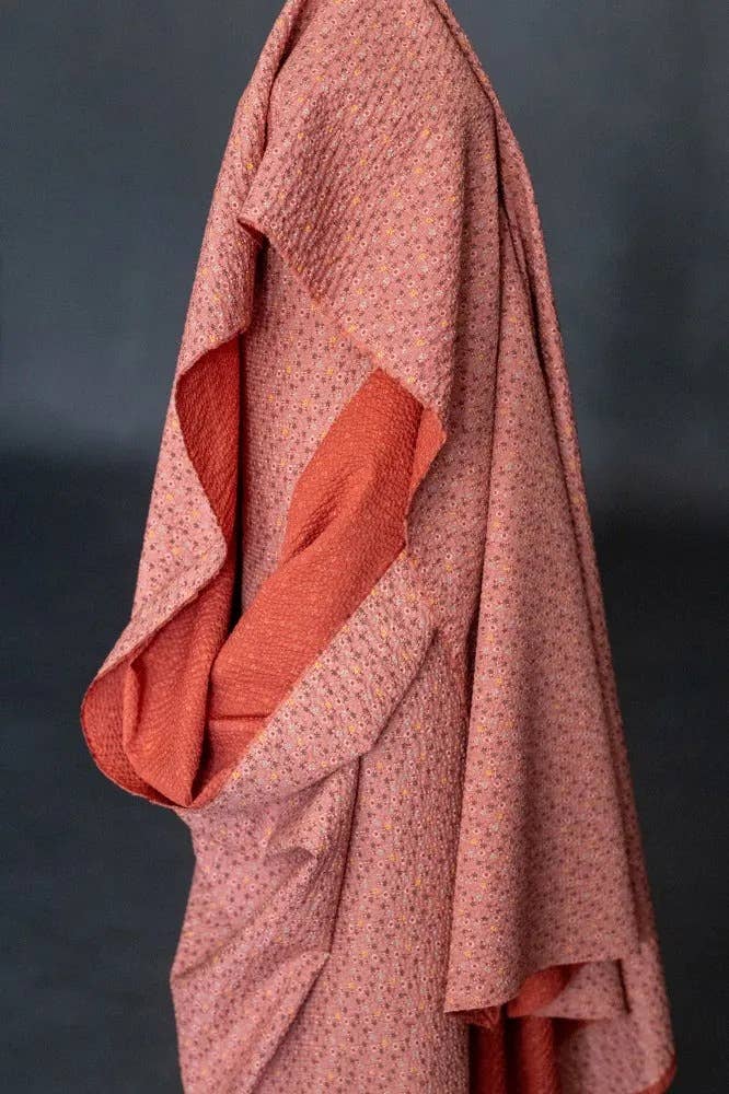Merchant & Mills Tulip Hana Japanese seersucker fabric, draped in coral and red