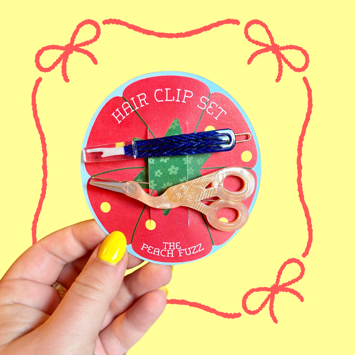 The Peach Fuzz sewing kit hair clip set with scissors, needle and thread clips on red