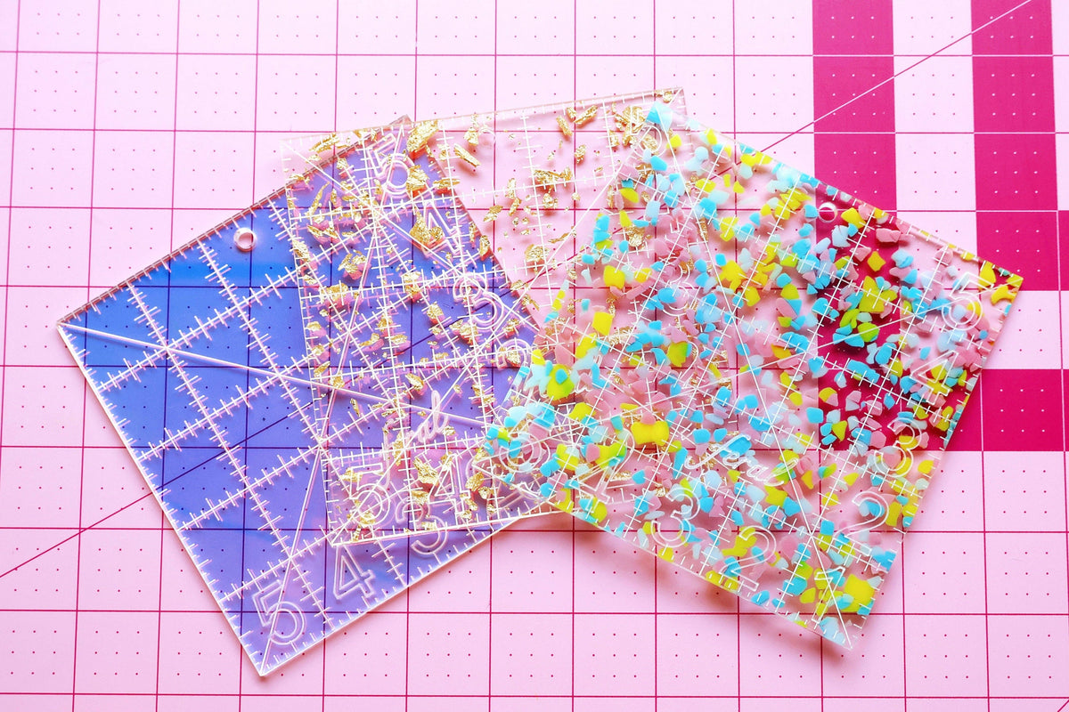Set of three Feral Notions 5 inch charm square quilting ruler in iridescent, confetti and gold glitter acrylic