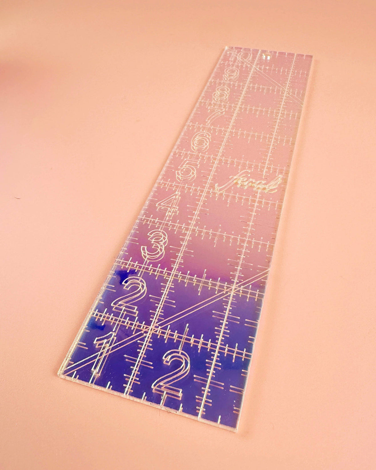 Feral Notions 2.5 x 10 inch quilting ruler in iridescent purple acrylic on peach