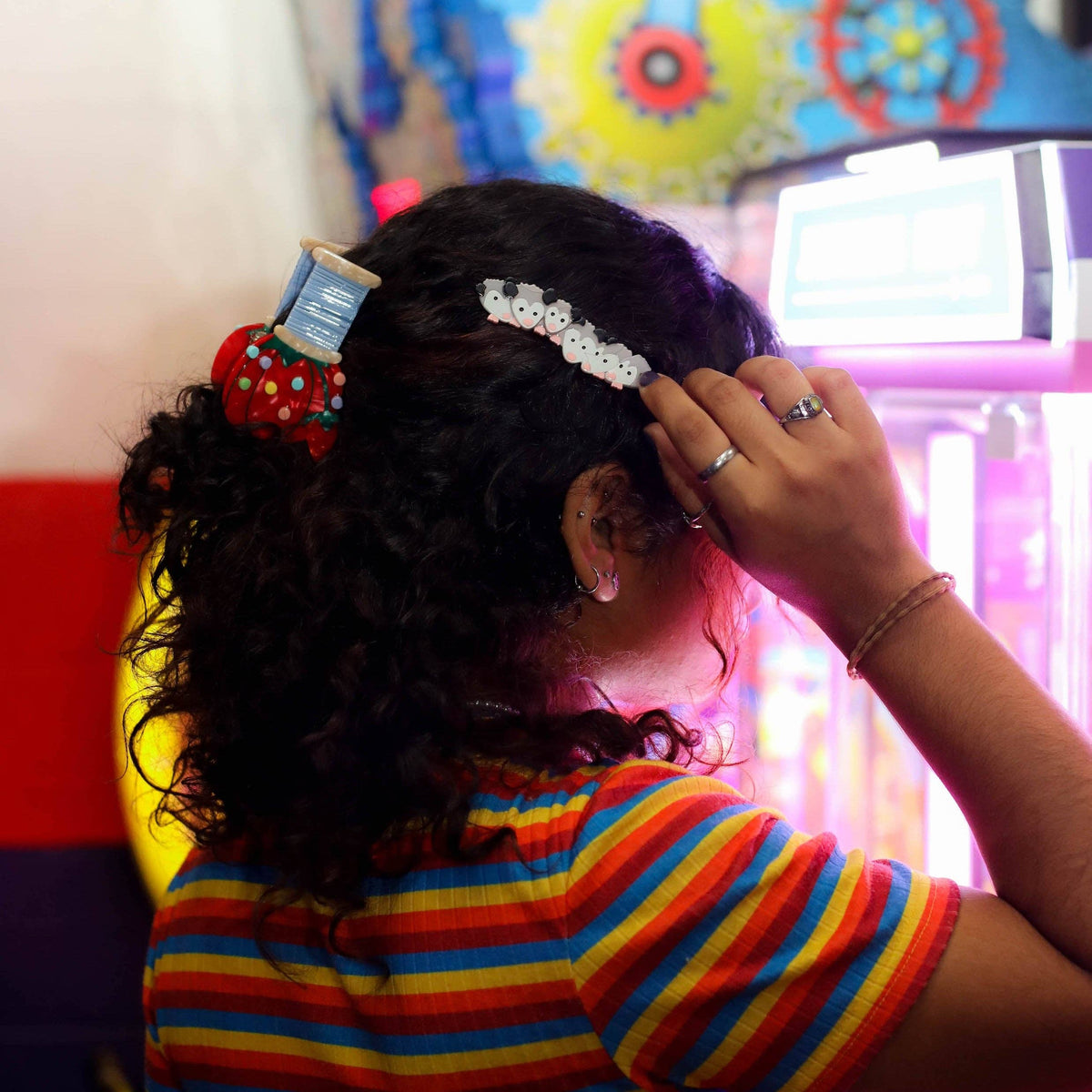 The Peach Fuzz pin cushion hair claw worn in curly hair, side view