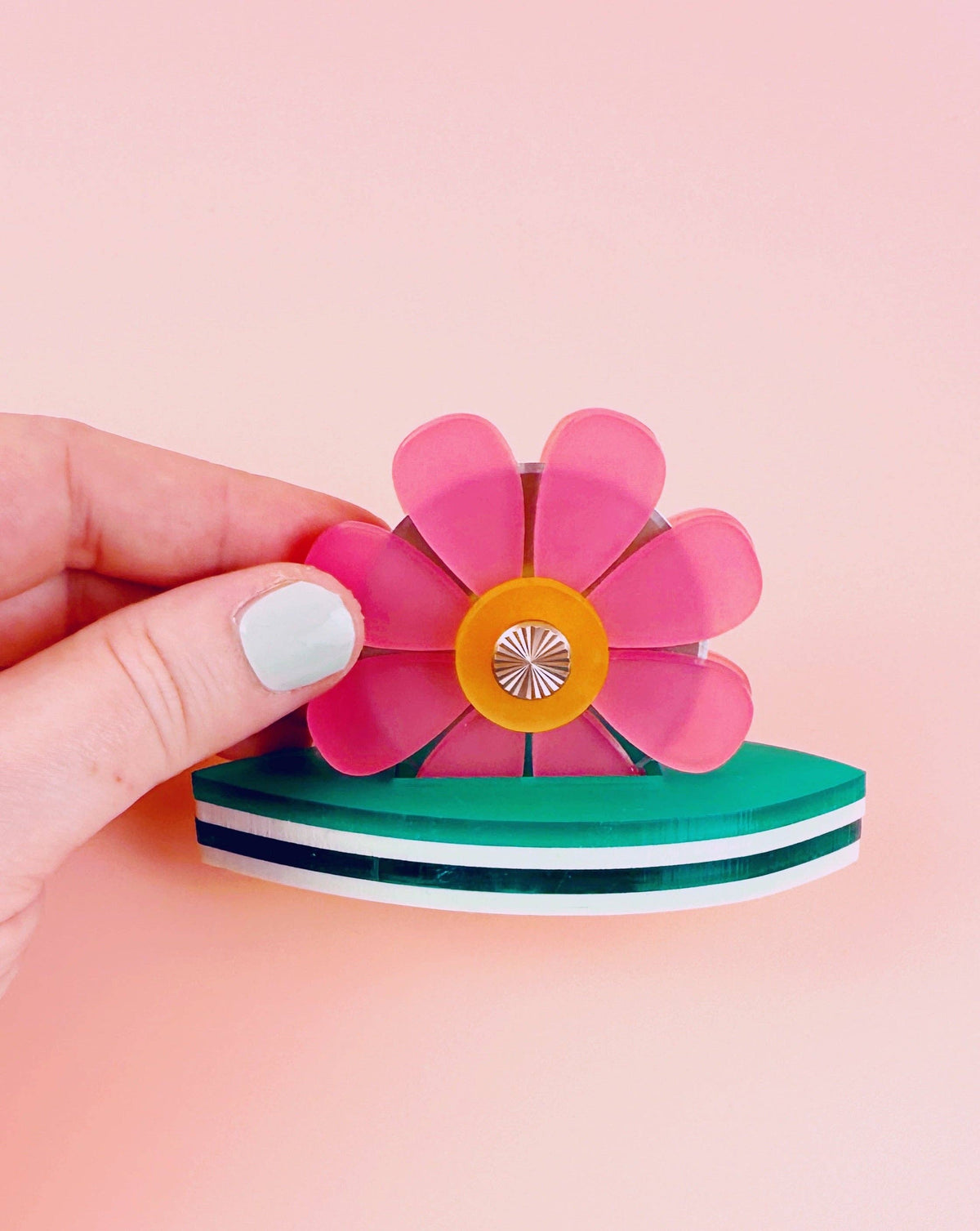 Feral Notions flower thread cutter held in hand, side view of the green leaf base