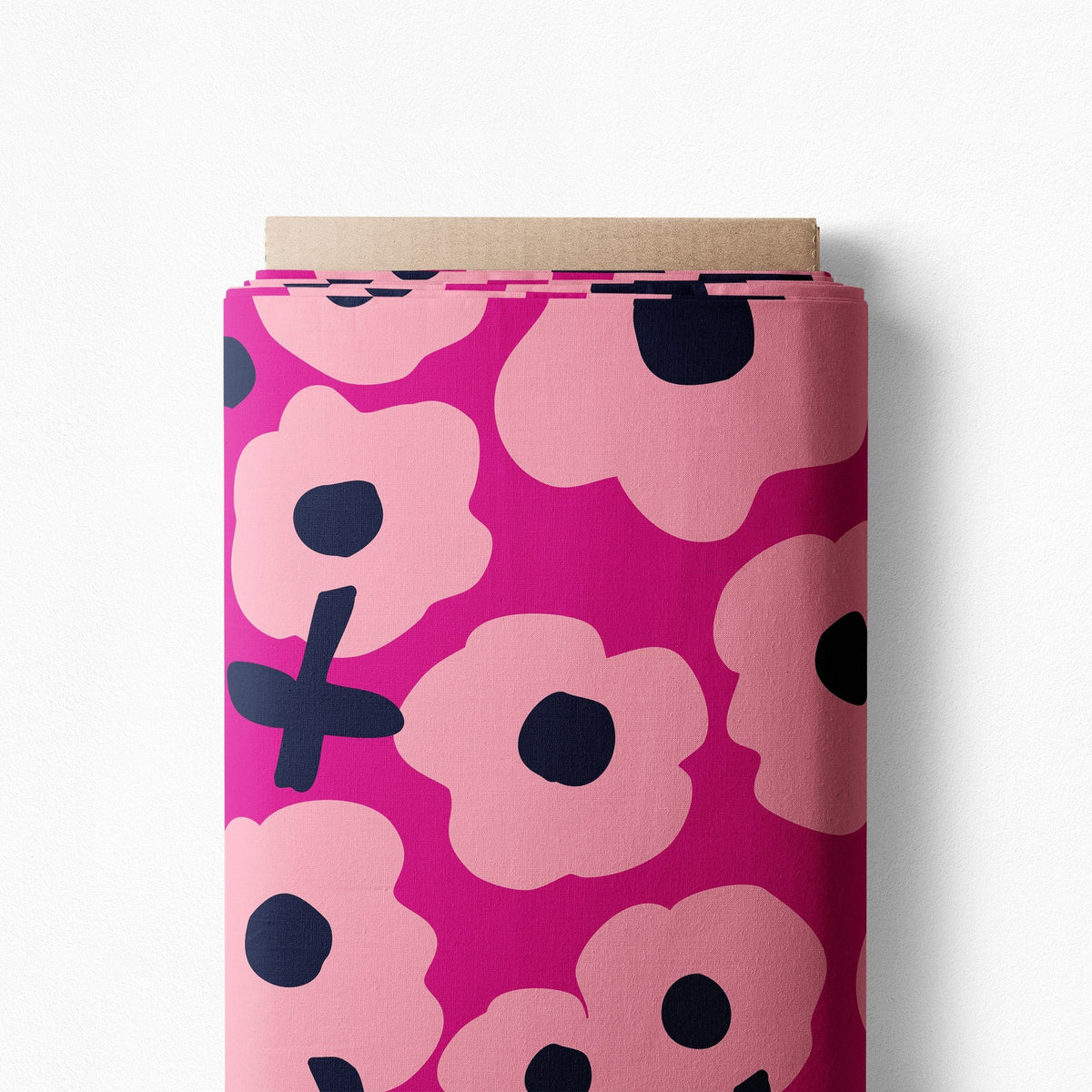 Bloomin Pops in Ruby cotton poplin on a bolt, pale pink flowers with navy centers on a magenta-pink background