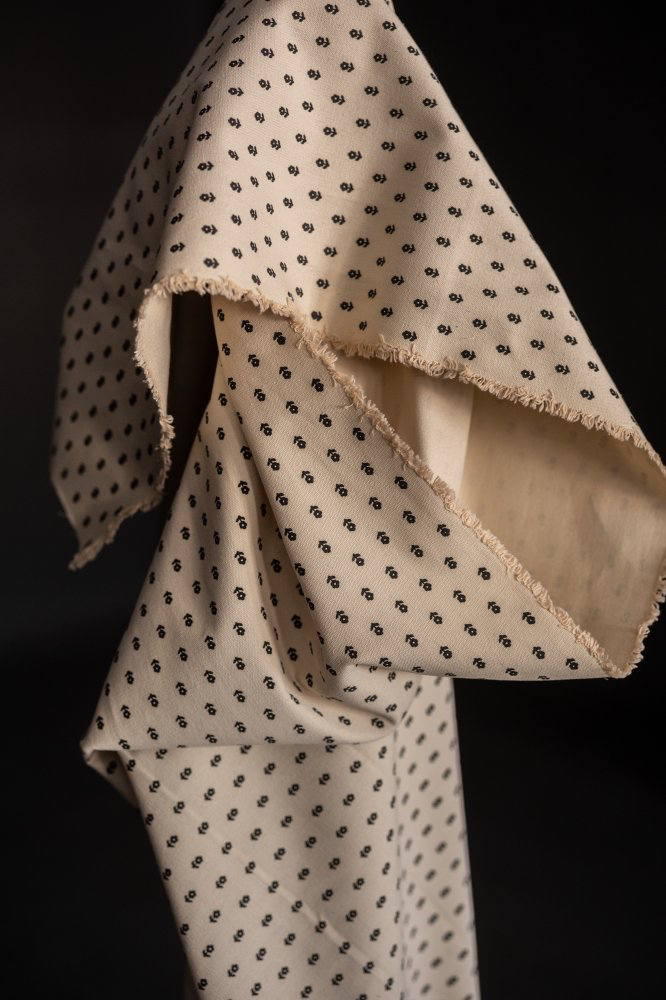 Merchant & Mills Dover Stone ditsy canvas in cream with a dark dot print, draped