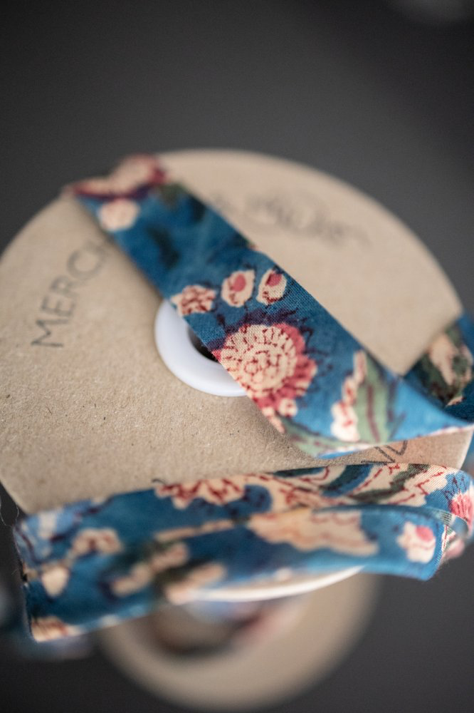 Merchant & Mills Storybook bias binding in blue floral on a wooden spool