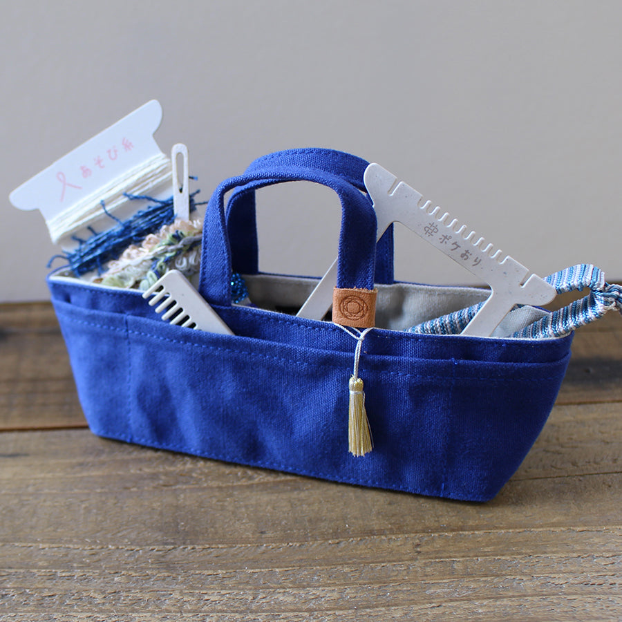 Cohana Pokeori mini loom weaving kit, weaving a pouch on a blue bag