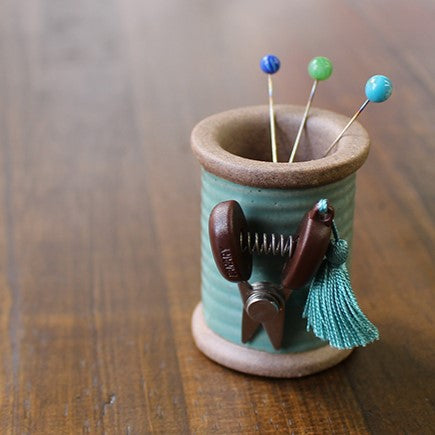 Cohana Hasami magnetic pin holder, on a wooden table holding pins