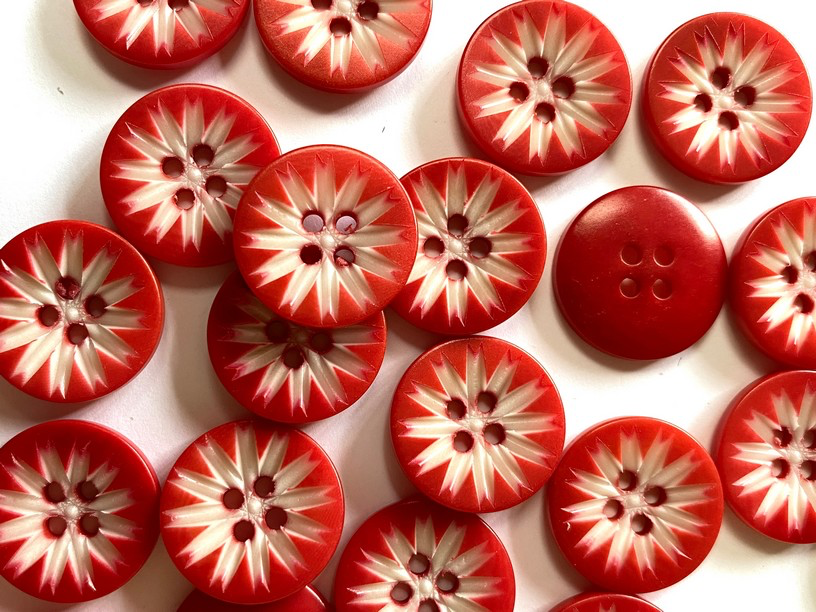 Red and white buttons with a starburst pattern on a white background