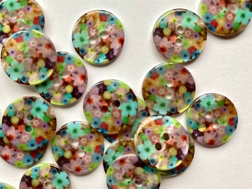 Colorful floral-patterned buttons on a white background