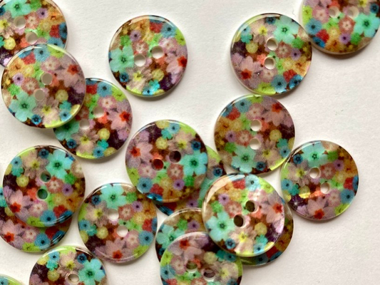Colorful floral-patterned buttons on a white background