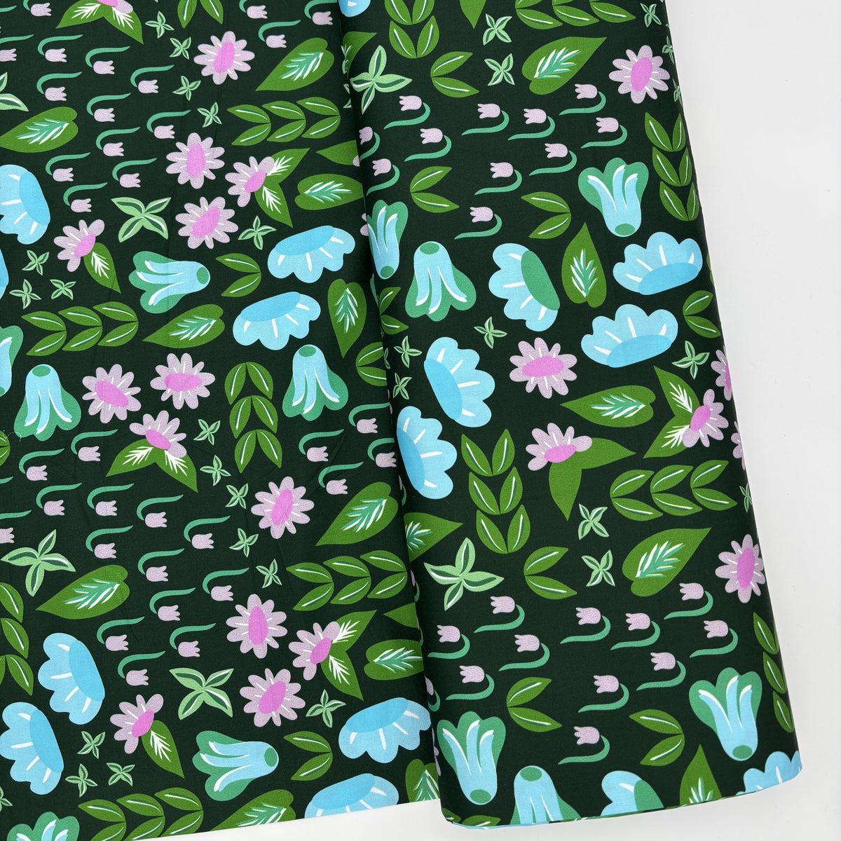 Lakewood printed fabric laid in soft folds, showing the blue bell flowers and leaves