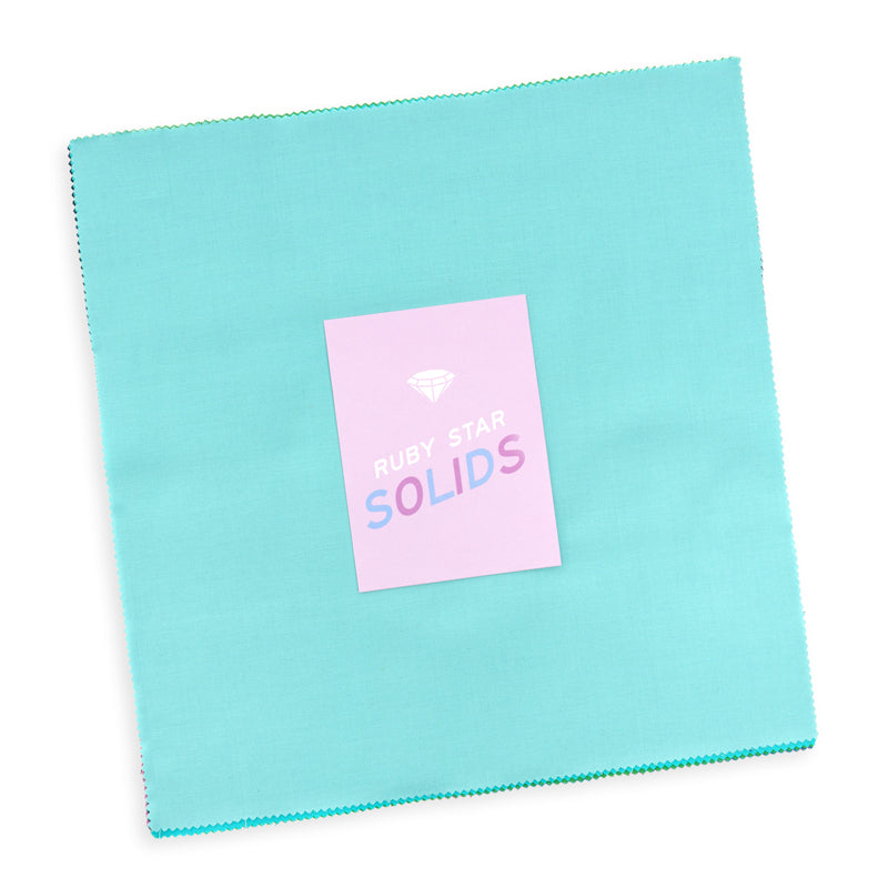 Ruby Star Society Ruby Star Solids layer cake, stacked 10 inch quilting cotton squares with pinked edges and an aqua top