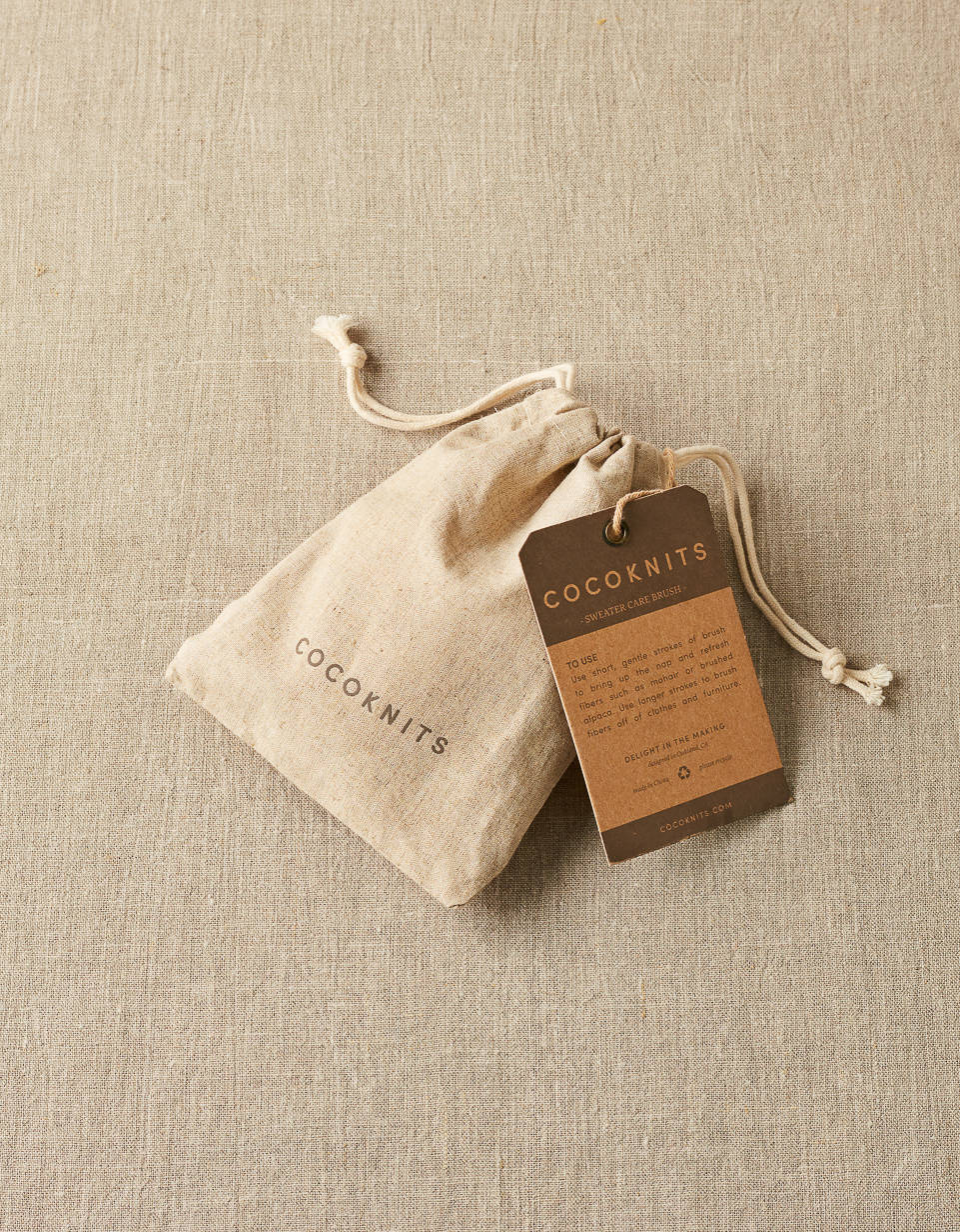 CocoKnits sweater care brush in its drawstring bag