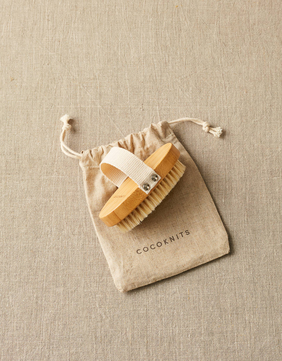 CocoKnits sweater care brush with wooden handle and cotton pouch