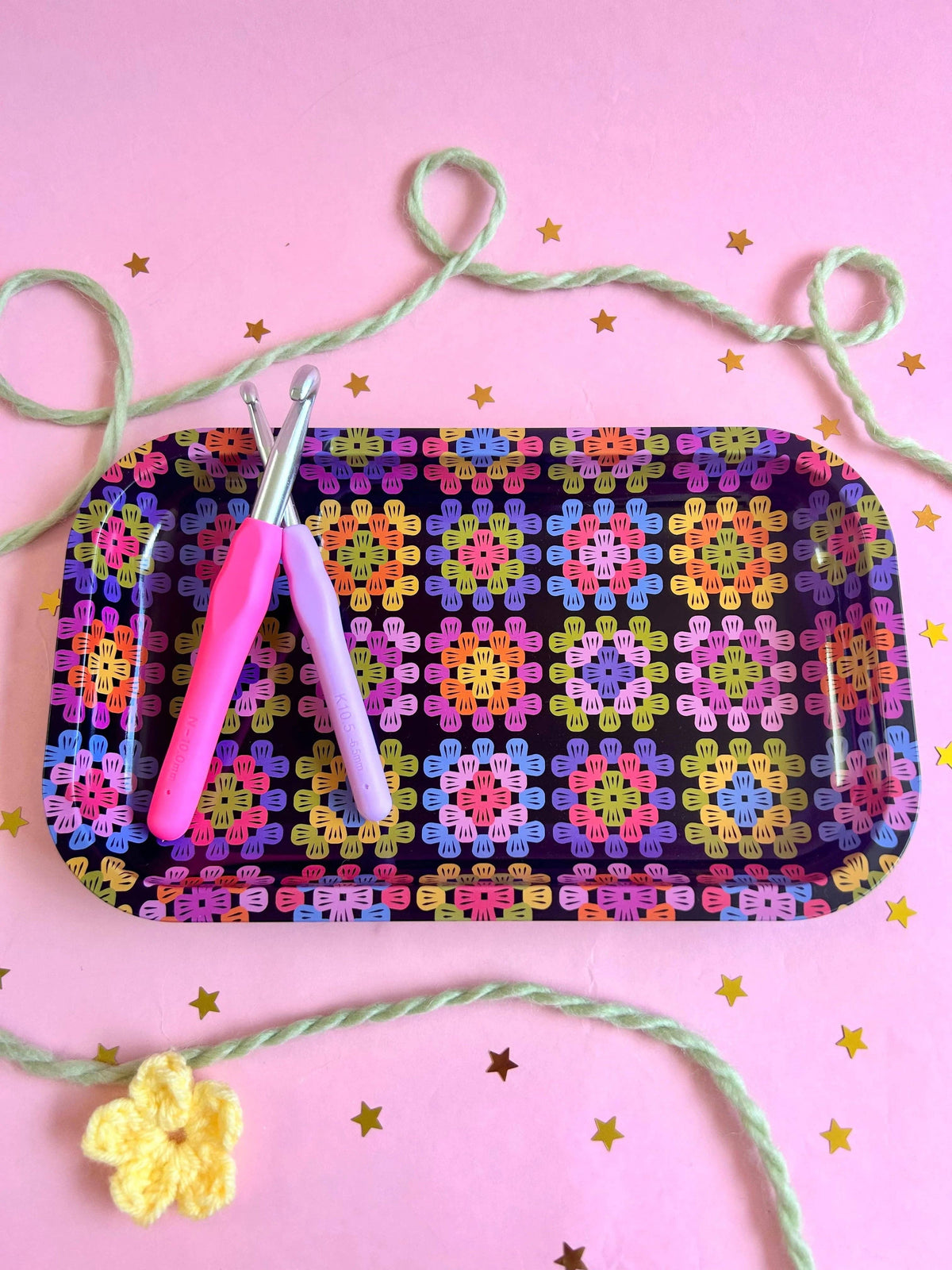 The Peach Fuzz granny square tray close-up with yarn and stitch markers