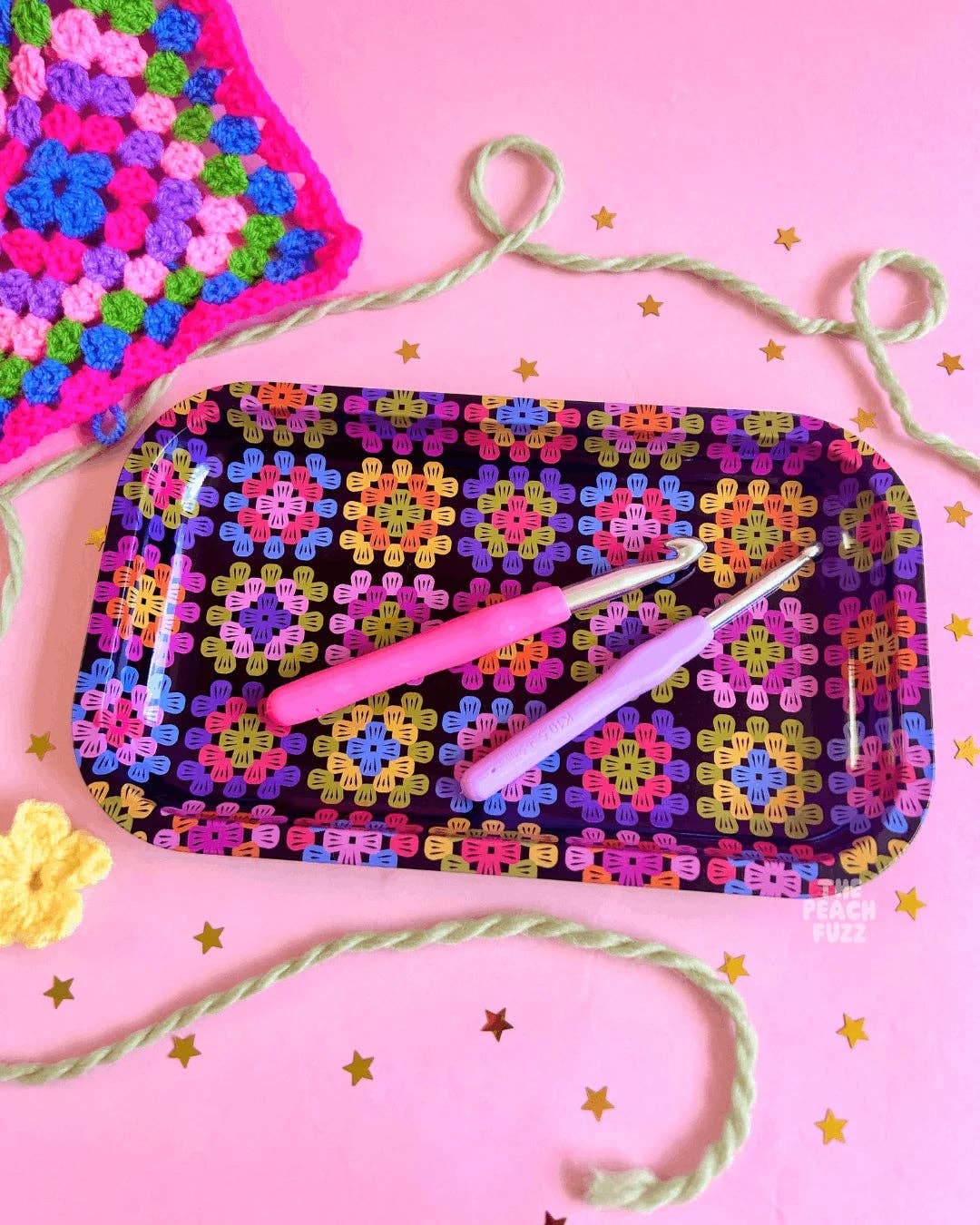 The Peach Fuzz large granny square tray holding crochet hooks and yarn, a gift for crocheters