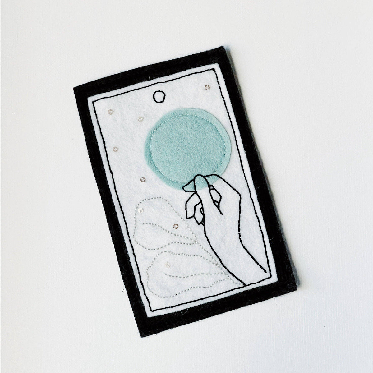 Sophie Hines The Fool tarot patch embroidery pattern printed card with a stitched hand holding a flower