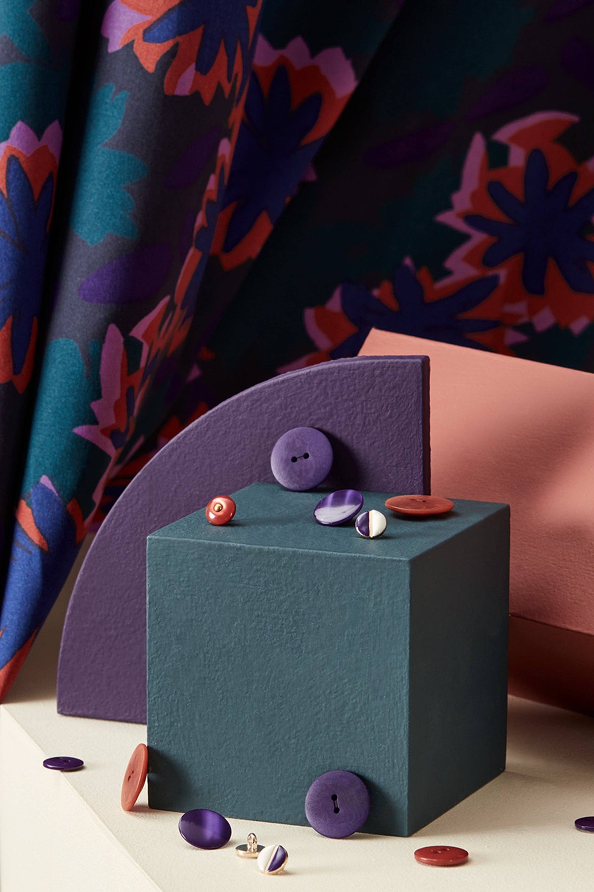 Atelier Brunette Waterlily Night fabric folded beside a gift box