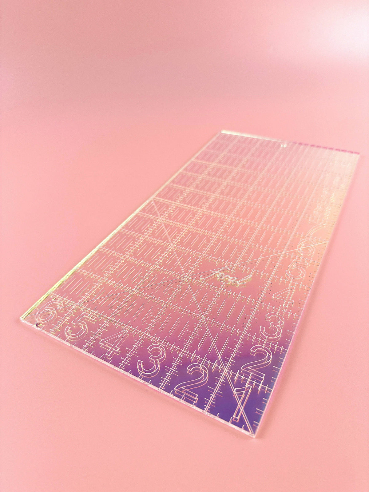 Feral Notions 6 x 12 inch quilting ruler in clear gold glitter acrylic on a peach background