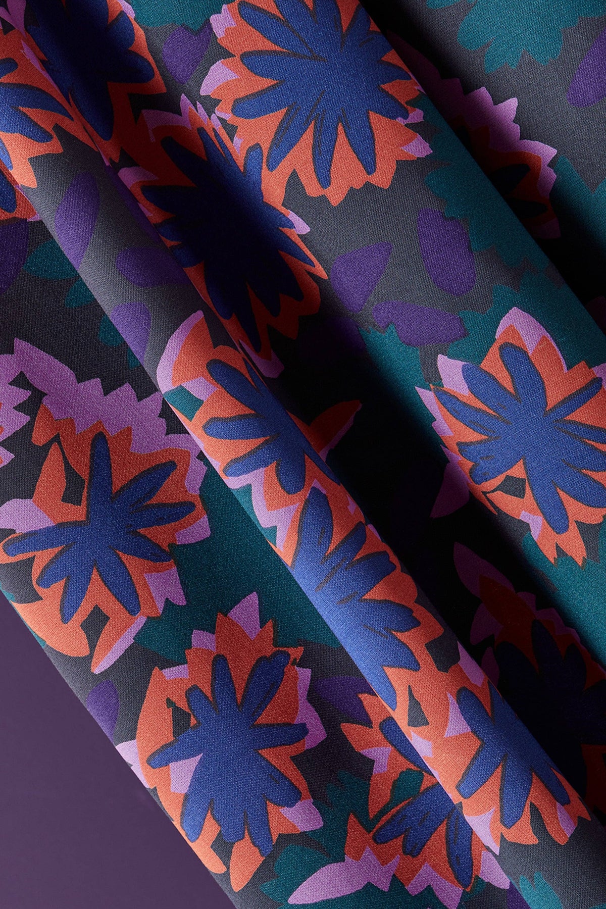 Atelier Brunette Waterlily Night navy and coral floral fabric close-up