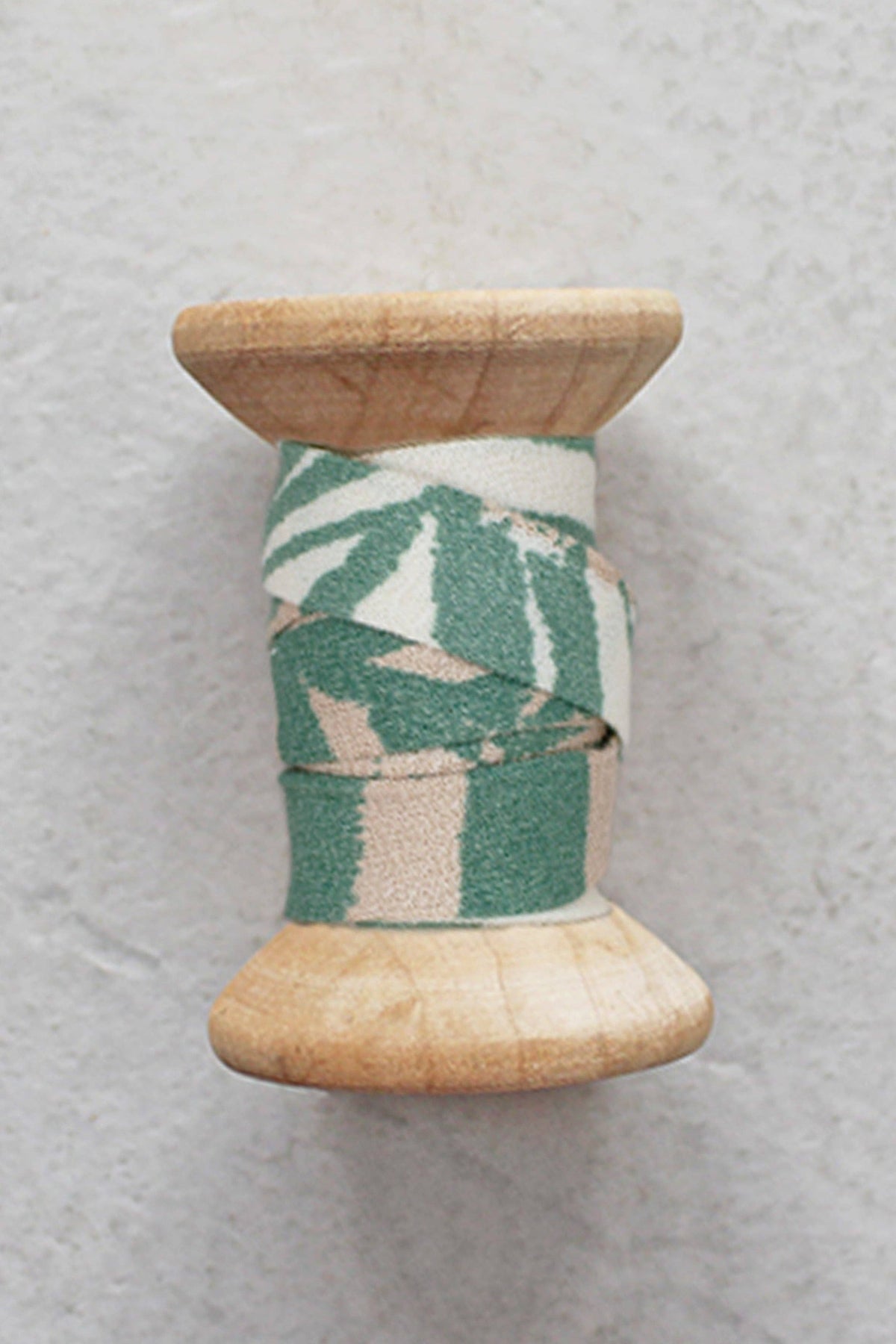 Atelier Brunette Canopy Cactus bias tape on a wooden spool, green print cotton bias binding