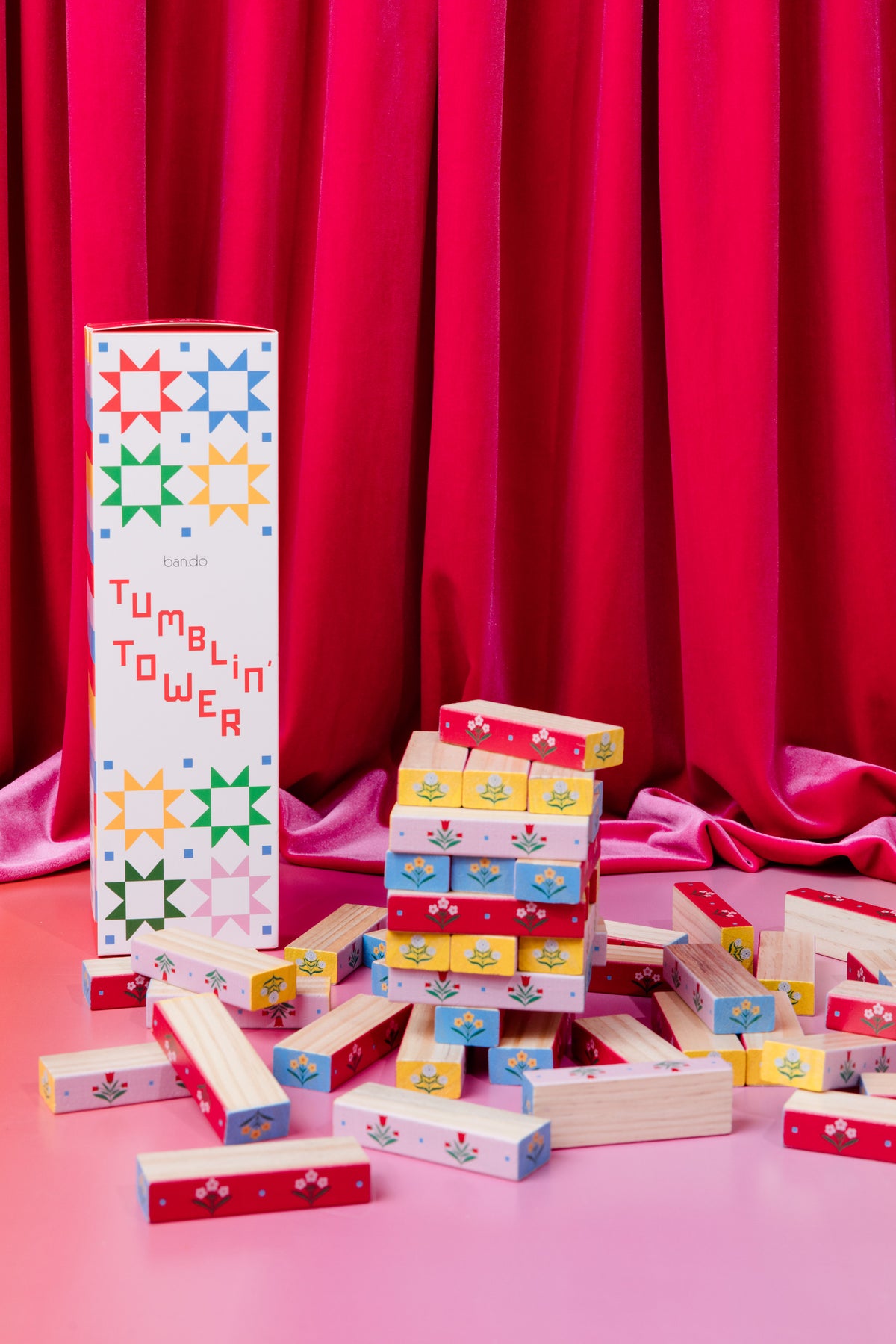 Ban.do Tumblin' Tower game on a table with blocks and sewing decor