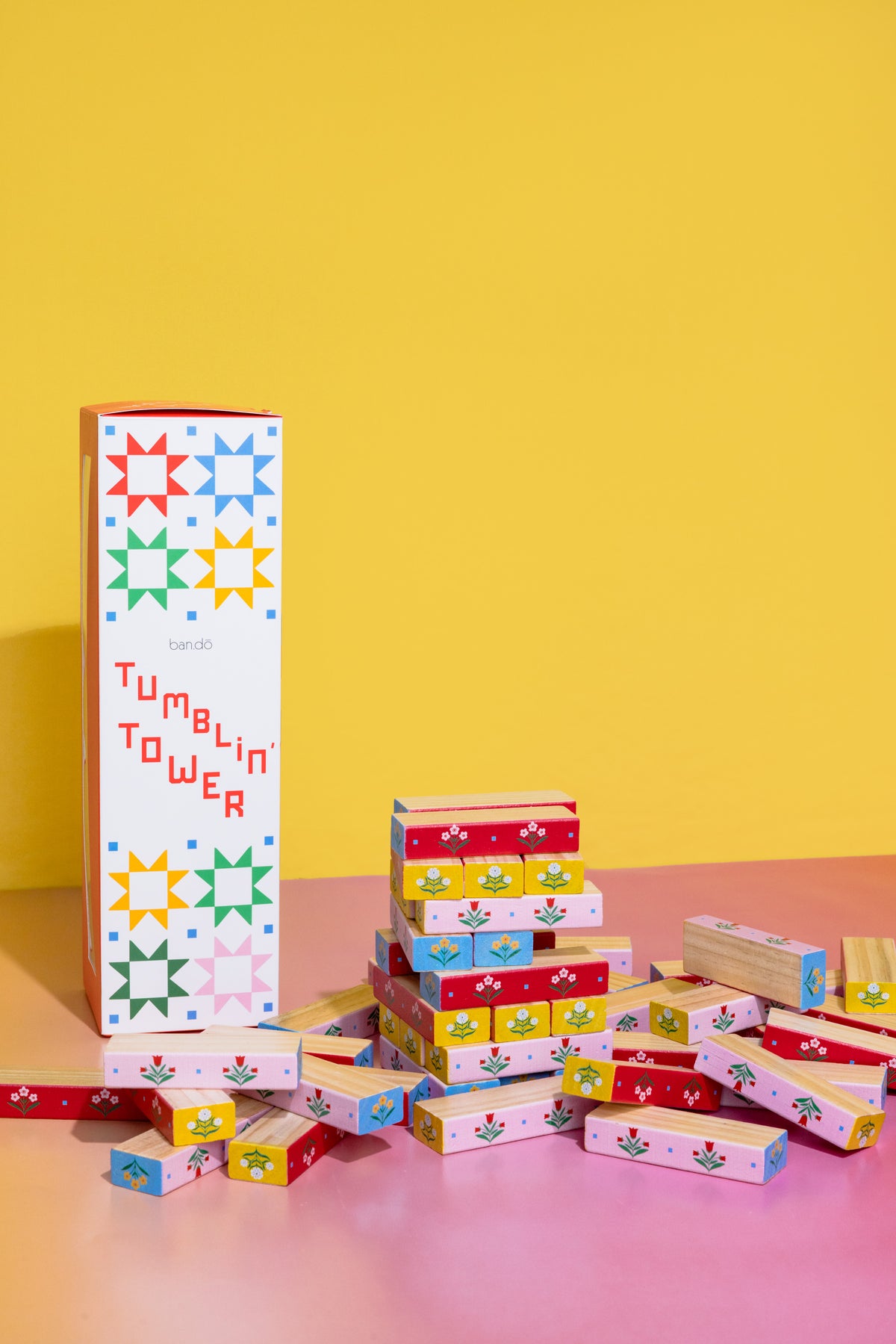 Ban.do Tumblin' Tower quilted blocks game box on a yellow background